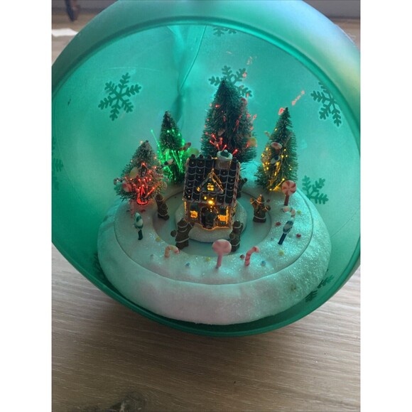 Animated Lighted Musical Ornament Plastic Gingerbread House Green Countertop - Picture 2 of 9